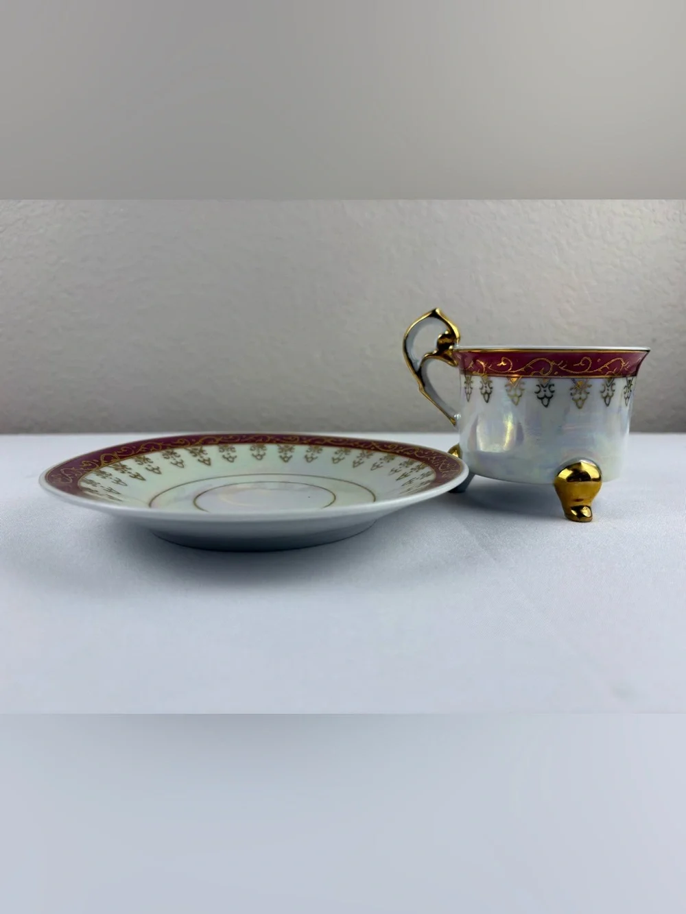 Vintage Porcelain Three-Legged Teacup and Saucer.